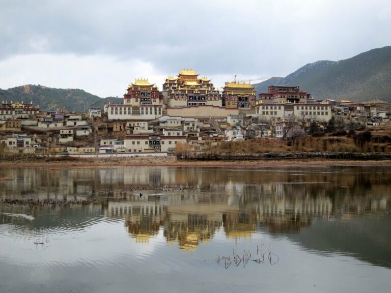 Ganden Sumtseling Monastery reflected in a lake