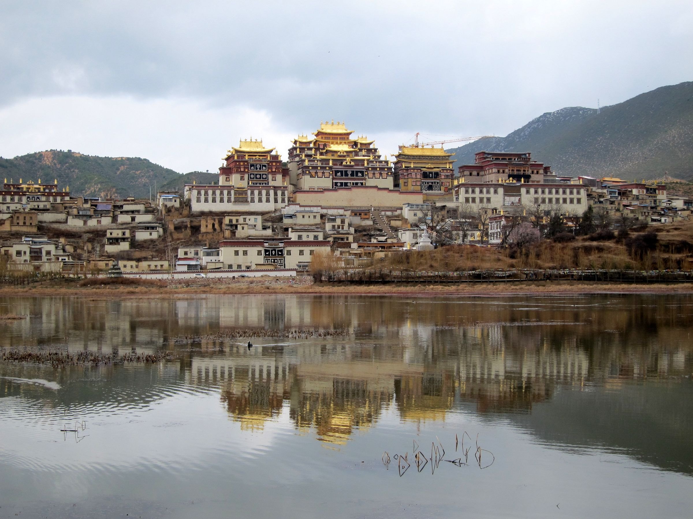 Ganden Sumtseling Monastery reflected in a lake