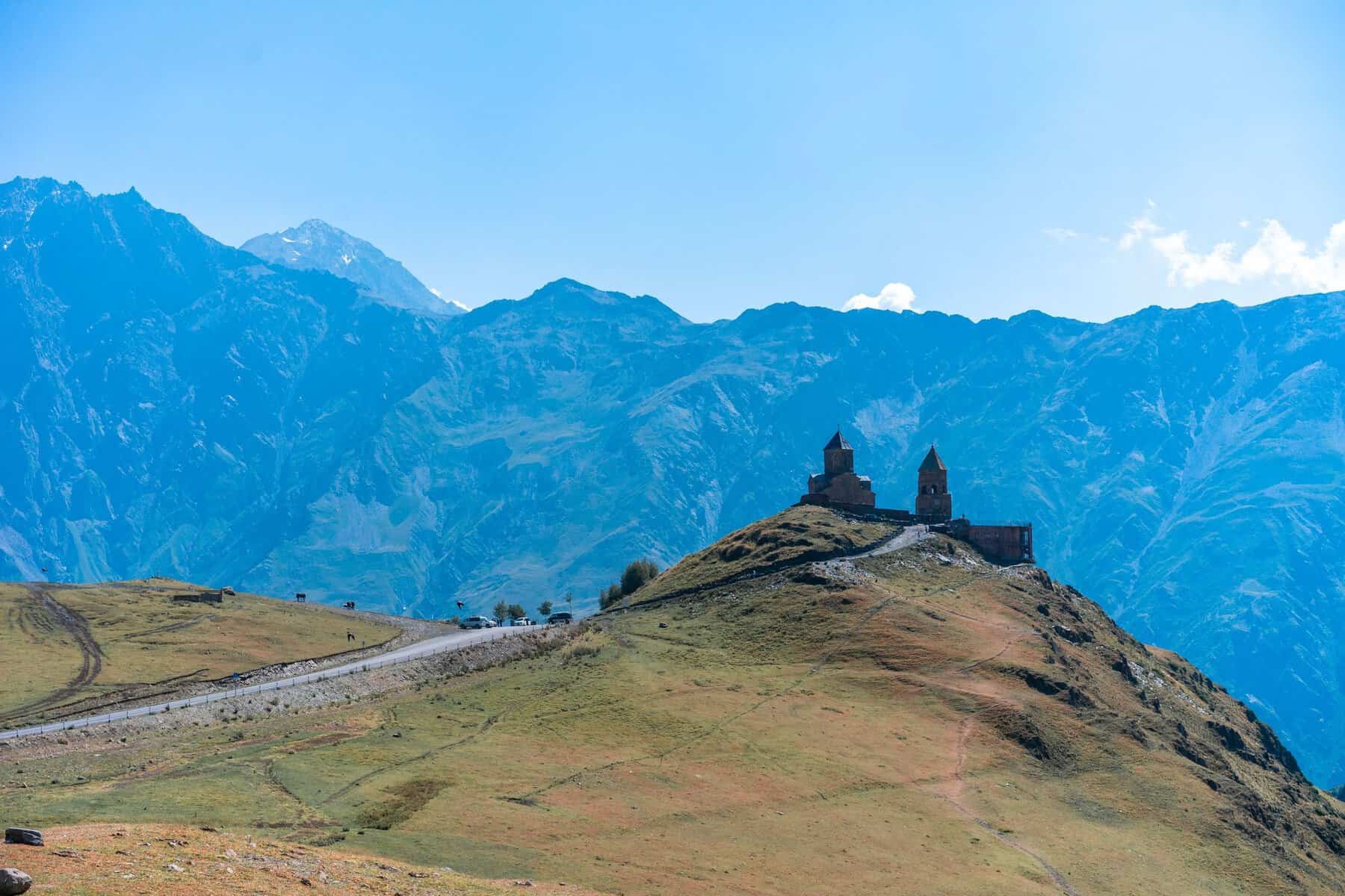 Gergeti Trinity Church on its hilltop beneath the Caucasus, Georgia