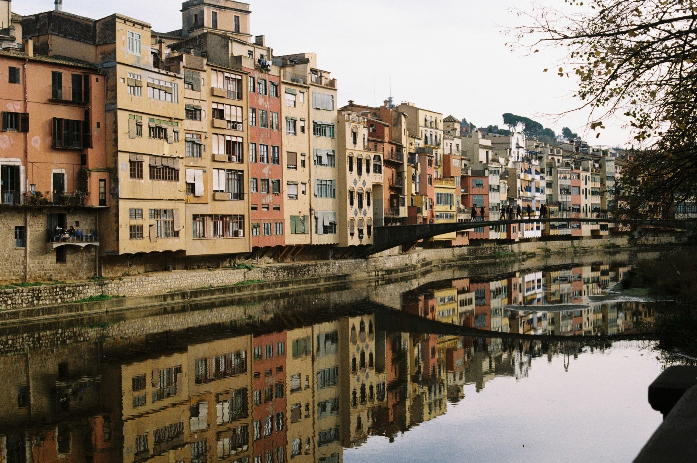 Colourful houses reflected in the Onyar River in Girona