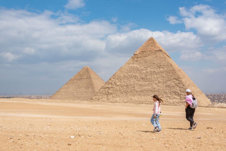 Visitors walking near the Pyramids of Giza