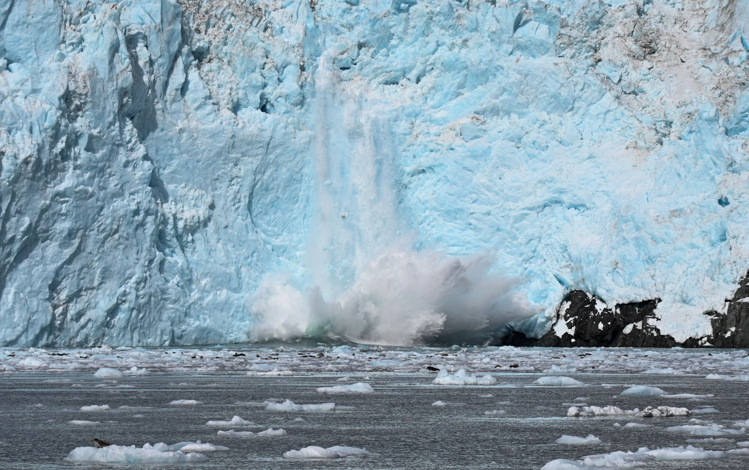 A glacier calving into the sea
