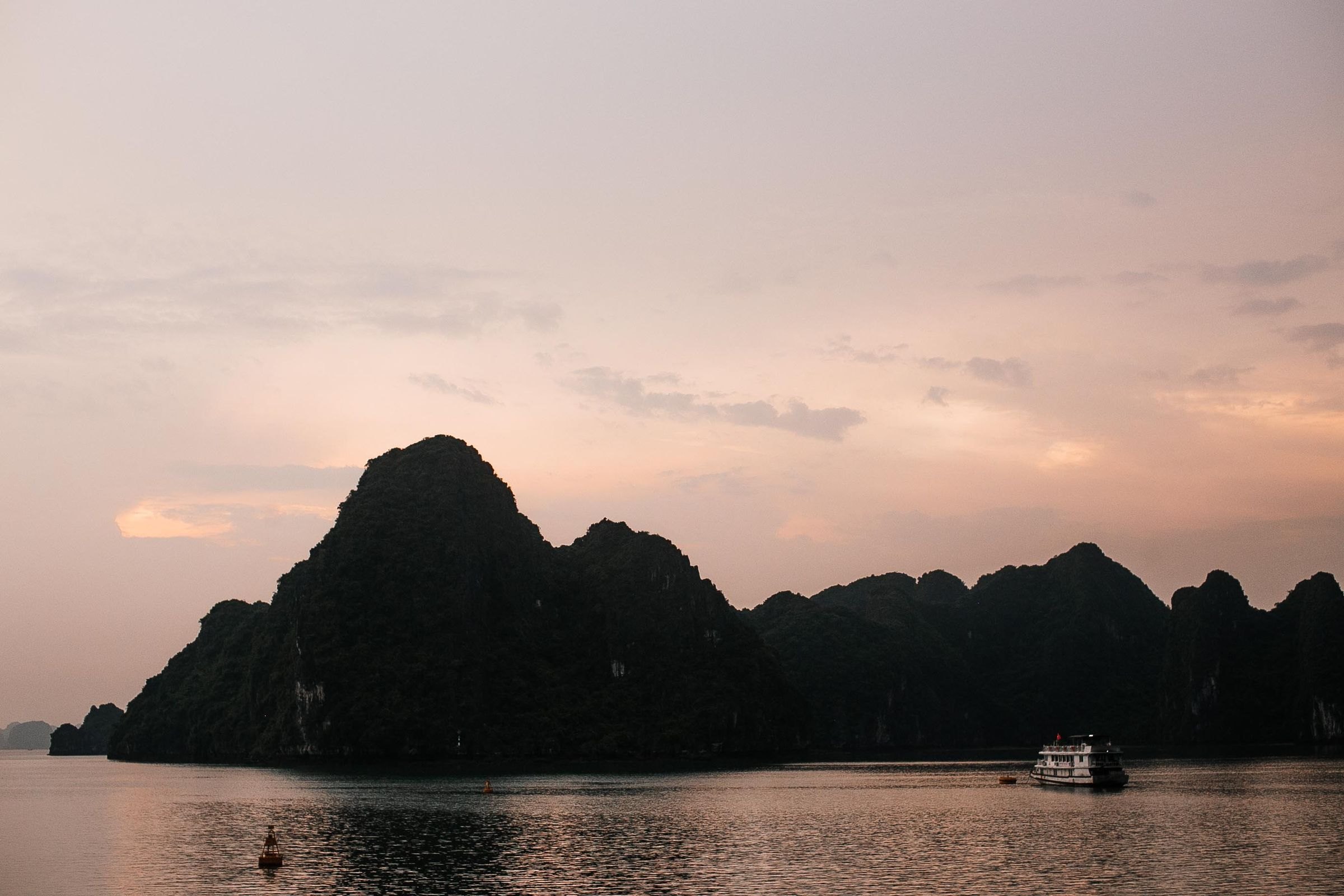 A boat on Ha Long Bay at sunset