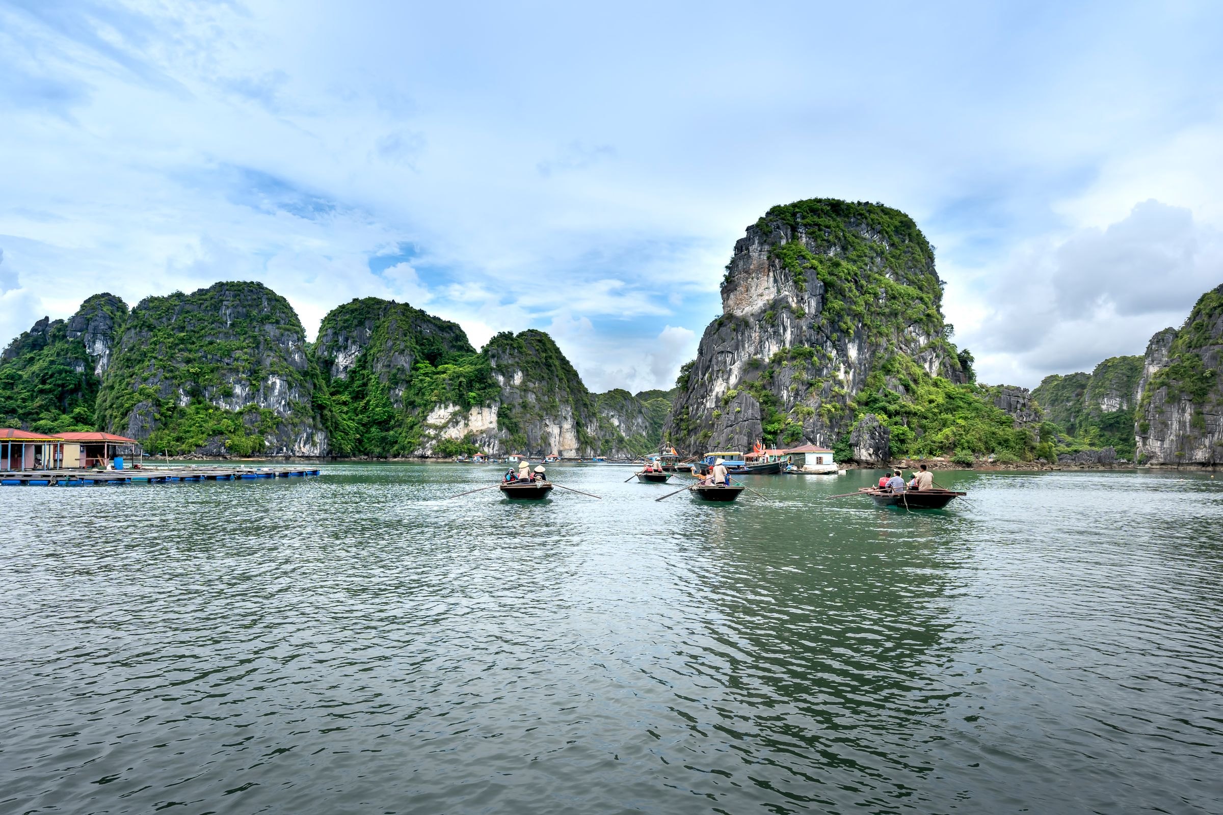 Boats among the karsts of Halong Bay