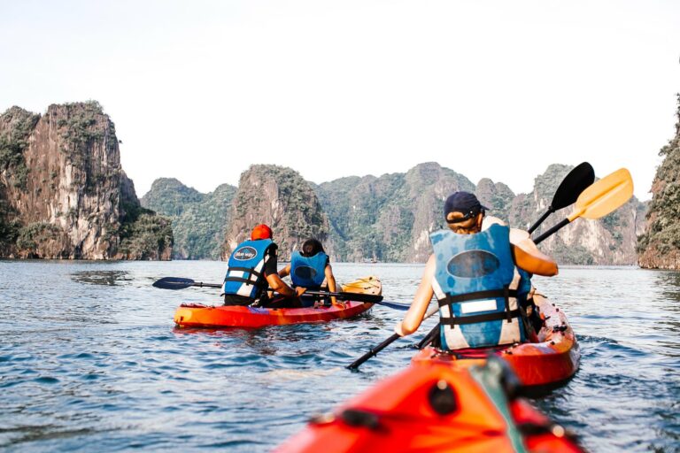 Kayakers among the limestone cliffs of Halong Bay