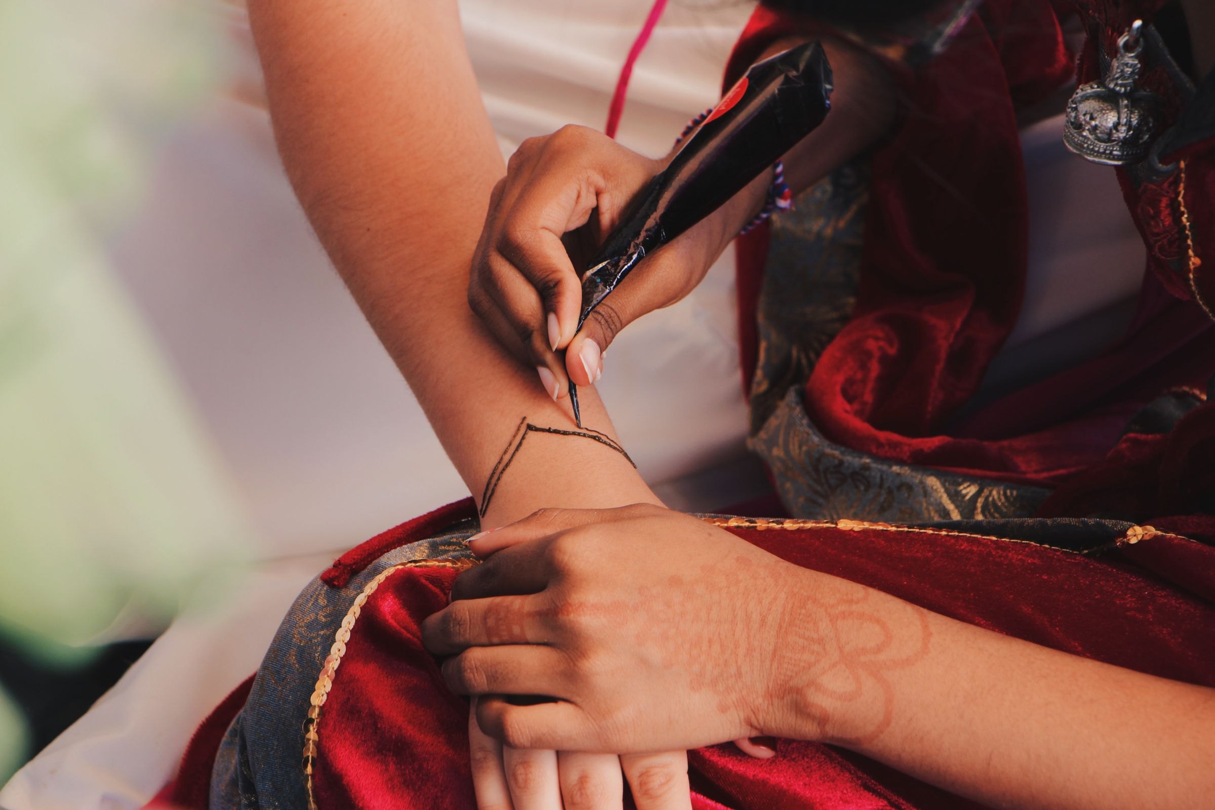 A henna design being painted on a hand