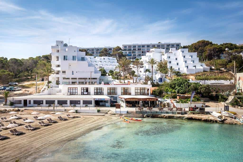 Sea-view pool terrace at Barceló Portinatx, adults-only hotel in Portinatx, Ibiza, overlooking a calm Balearic cove