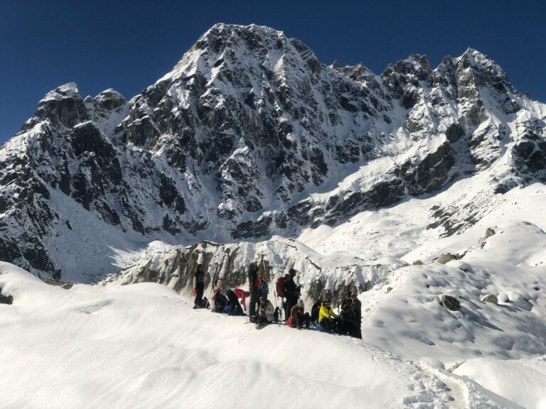 A group of climbers ascending a snowy Himalayan peak