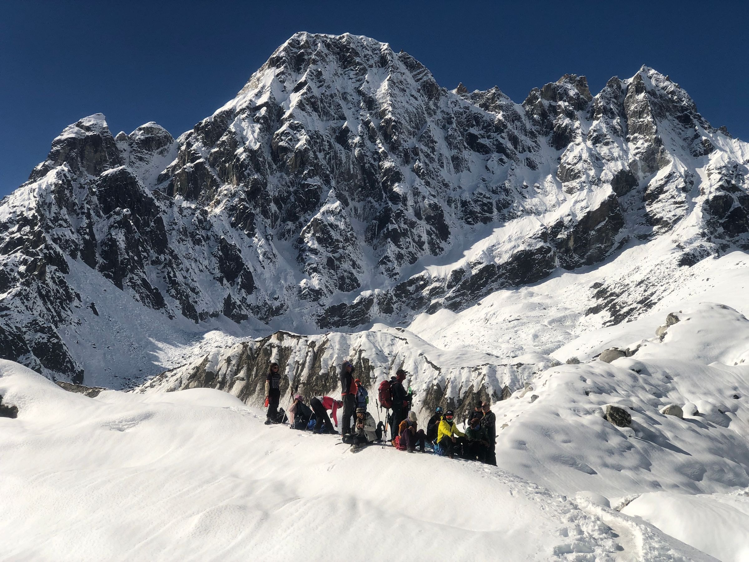 A group of climbers ascending a snowy Himalayan peak