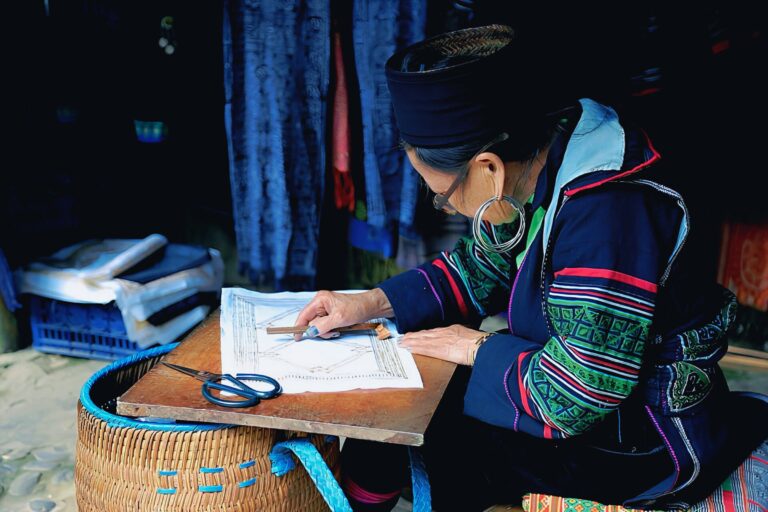 A Hmong woman making traditional handicrafts in Lao Cai