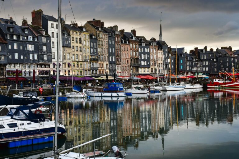 Colourful houses and boats in Honfleur harbour