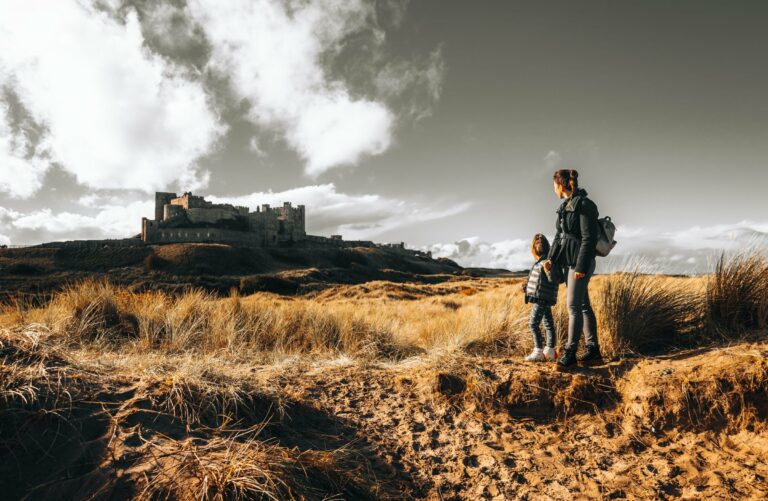 Walkers exploring ancient castle ruins