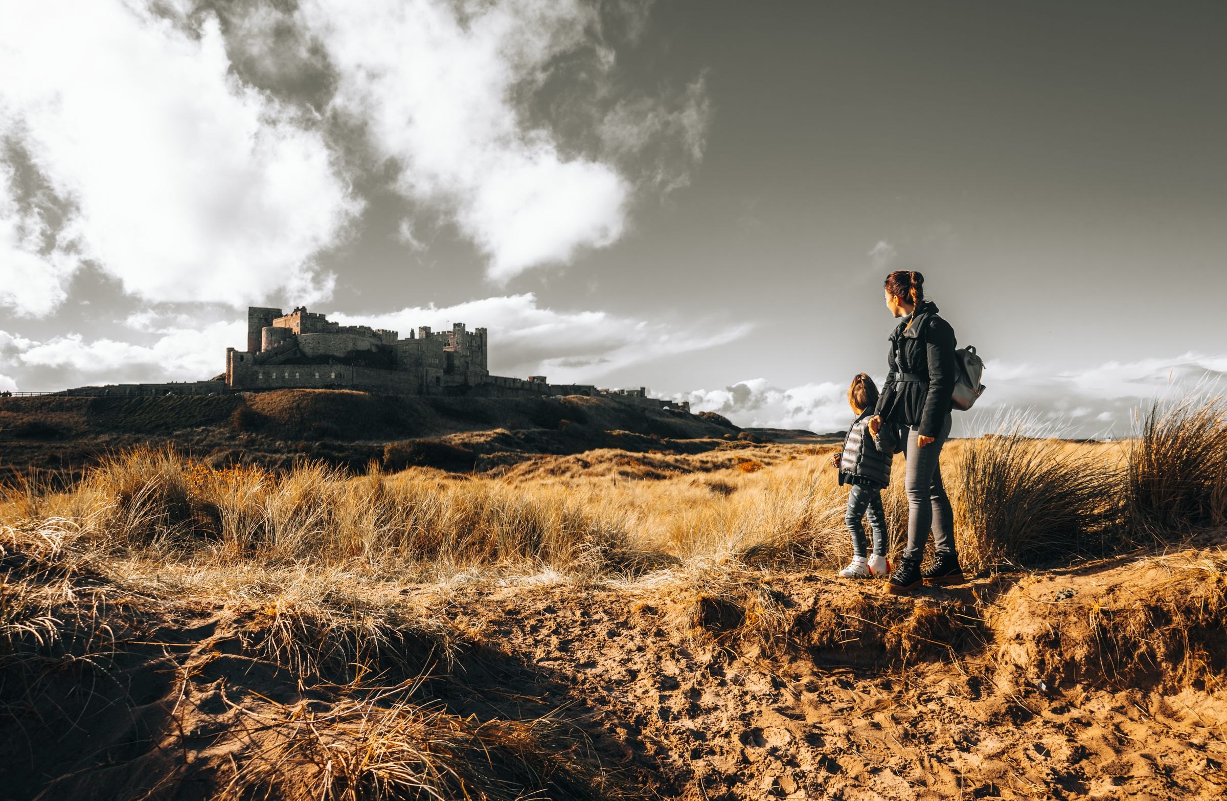 Walkers exploring ancient castle ruins