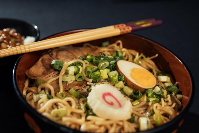 A bowl of Japanese ramen with egg and spring onions