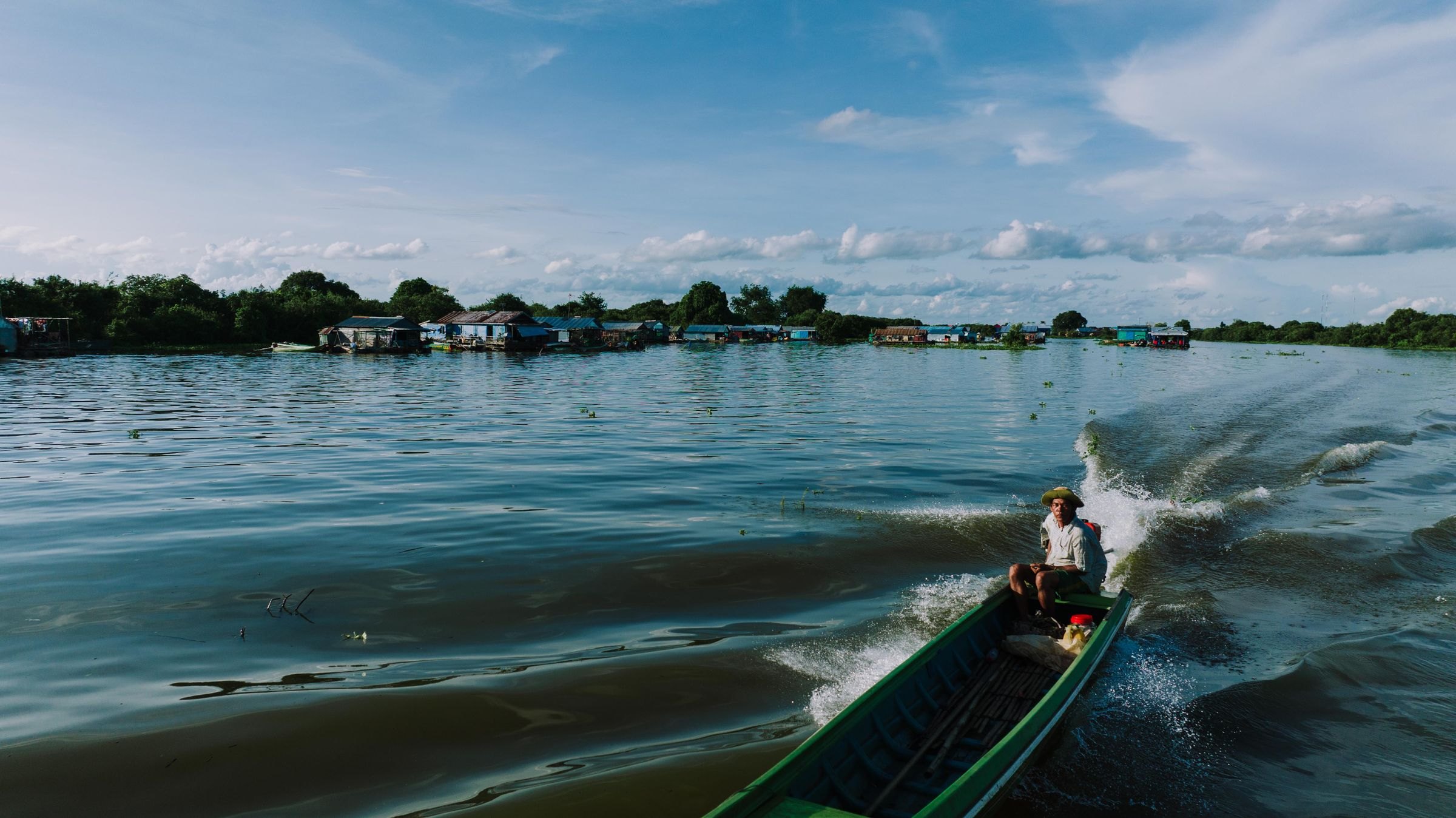 A boat speeding through Kampong Khleang