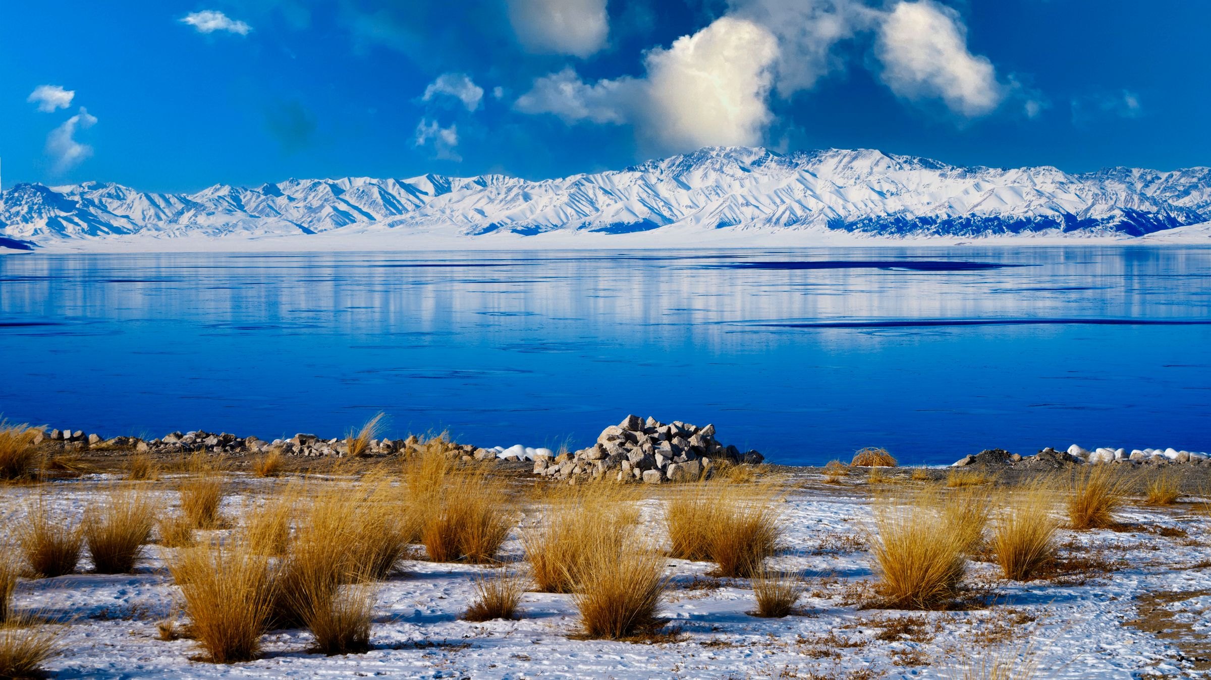 Karakul Lake below snow-capped peaks