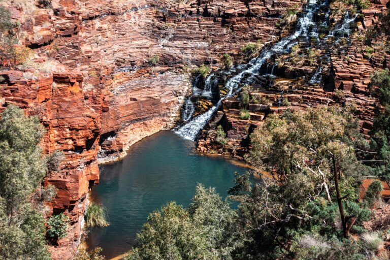 A waterfall over red cliffs in Karijini National Park
