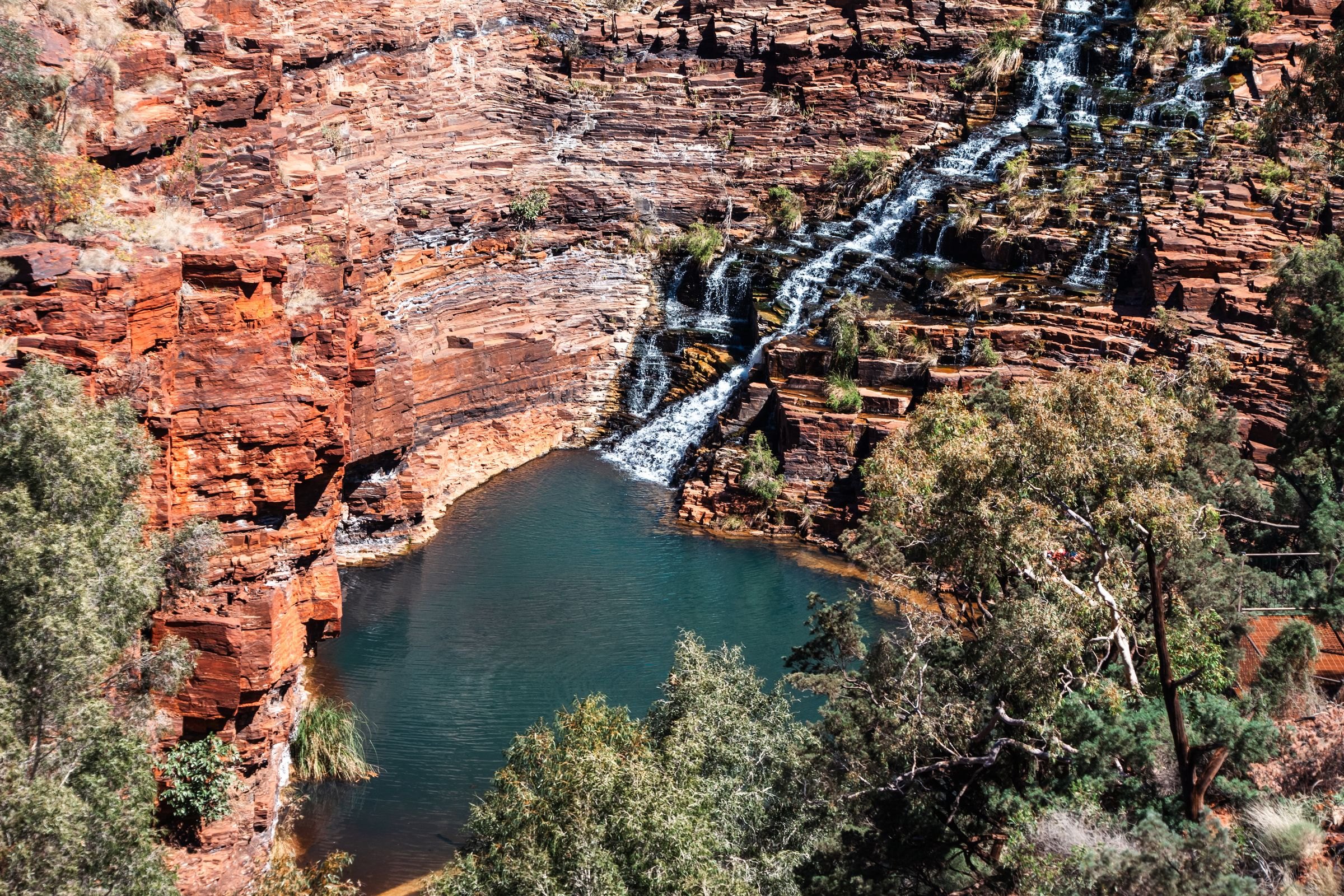 A waterfall over red cliffs in Karijini National Park