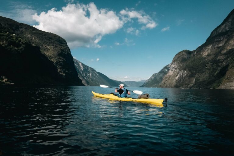 A kayaker paddling a Norwegian fjord