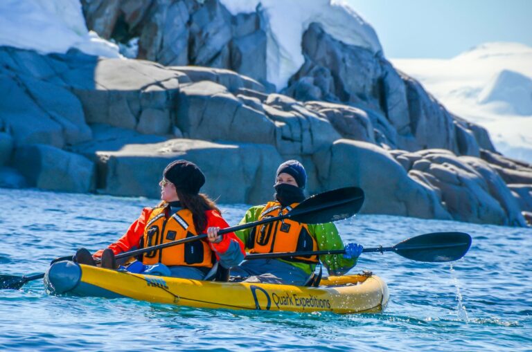 Two kayakers among the ice in Antarctica
