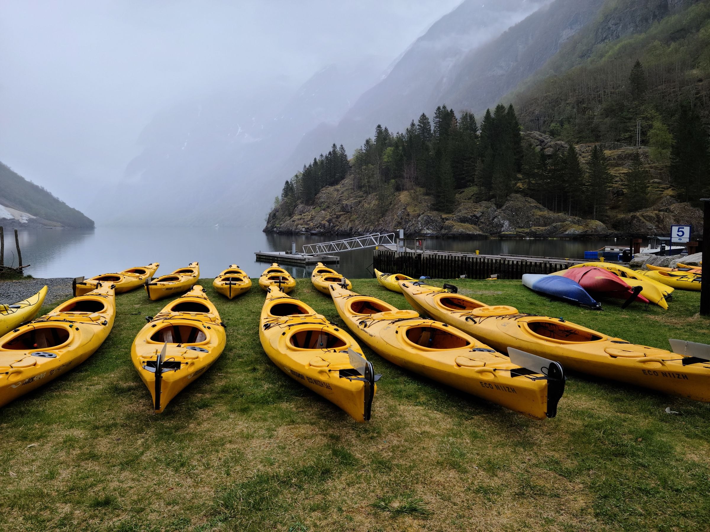 Yellow kayaks on the shore of a Norwegian fjord