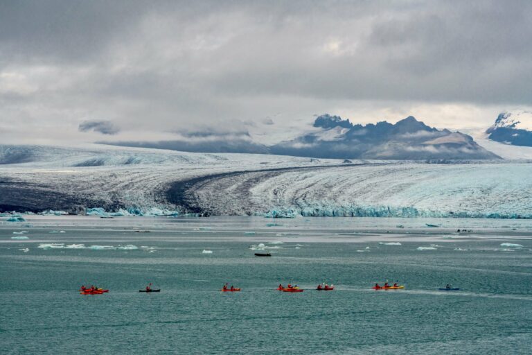 Kayakers paddling near a glacier in Iceland
