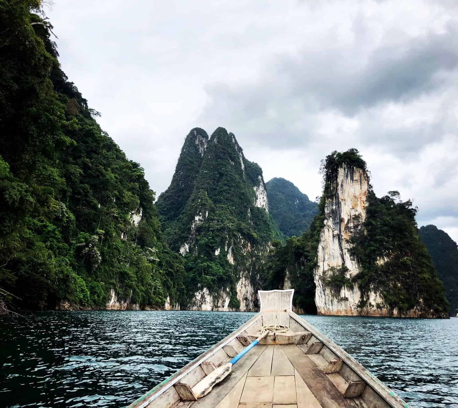 A longtail boat among the limestone cliffs of Cheow Lan Lake, Khao Sok