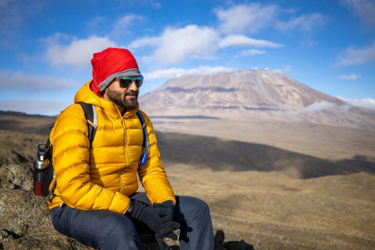 A hiker resting on the slopes of Kilimanjaro
