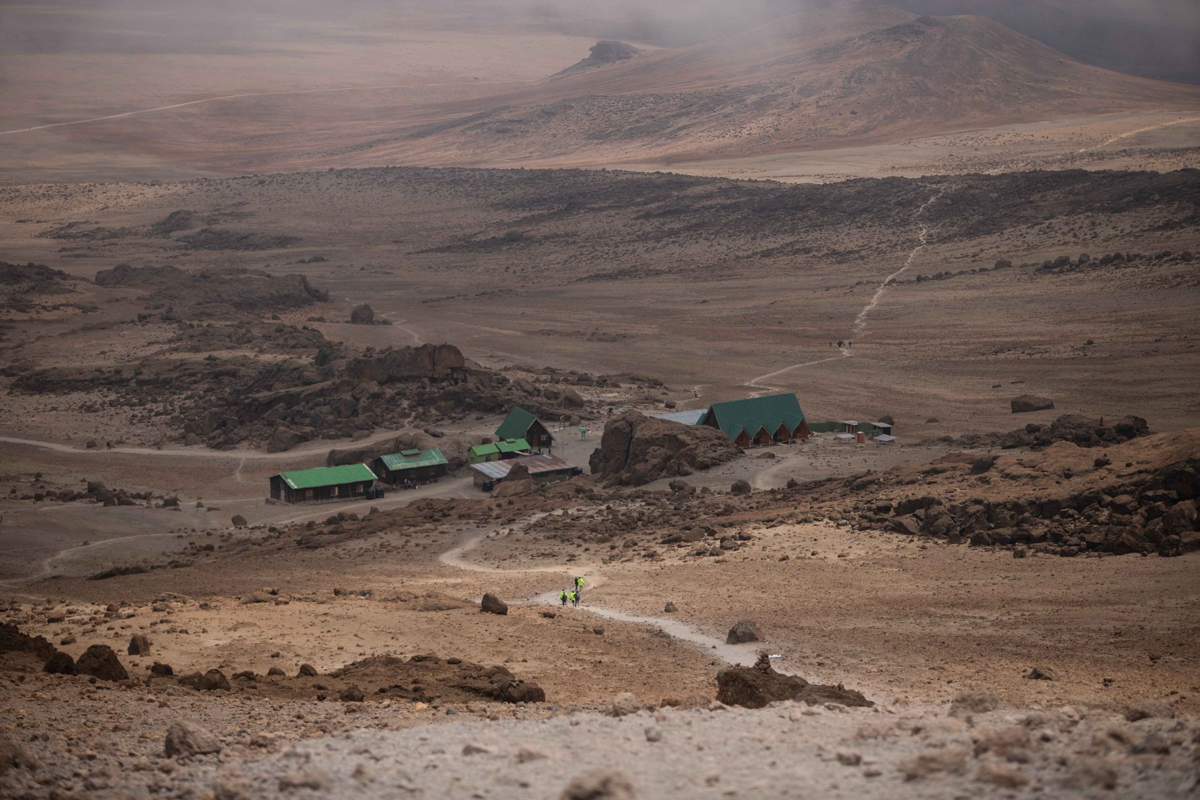 Hikers approaching a mountain camp on Kilimanjaro