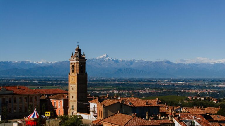 The bell tower of La Morra with the Alps behind