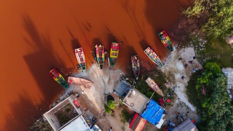 Aerial view of fishing pirogues at the edge of the Pink Lake (Lac Rose), Senegal