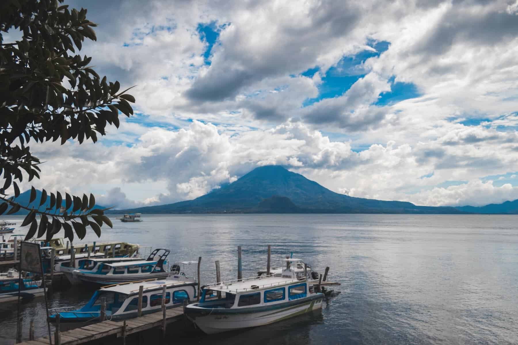 Boats on Lake Atitlán with a volcano behind, Guatemala