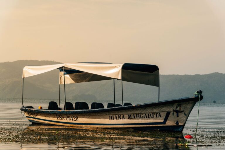 A boat on Lake Coatepeque at dawn