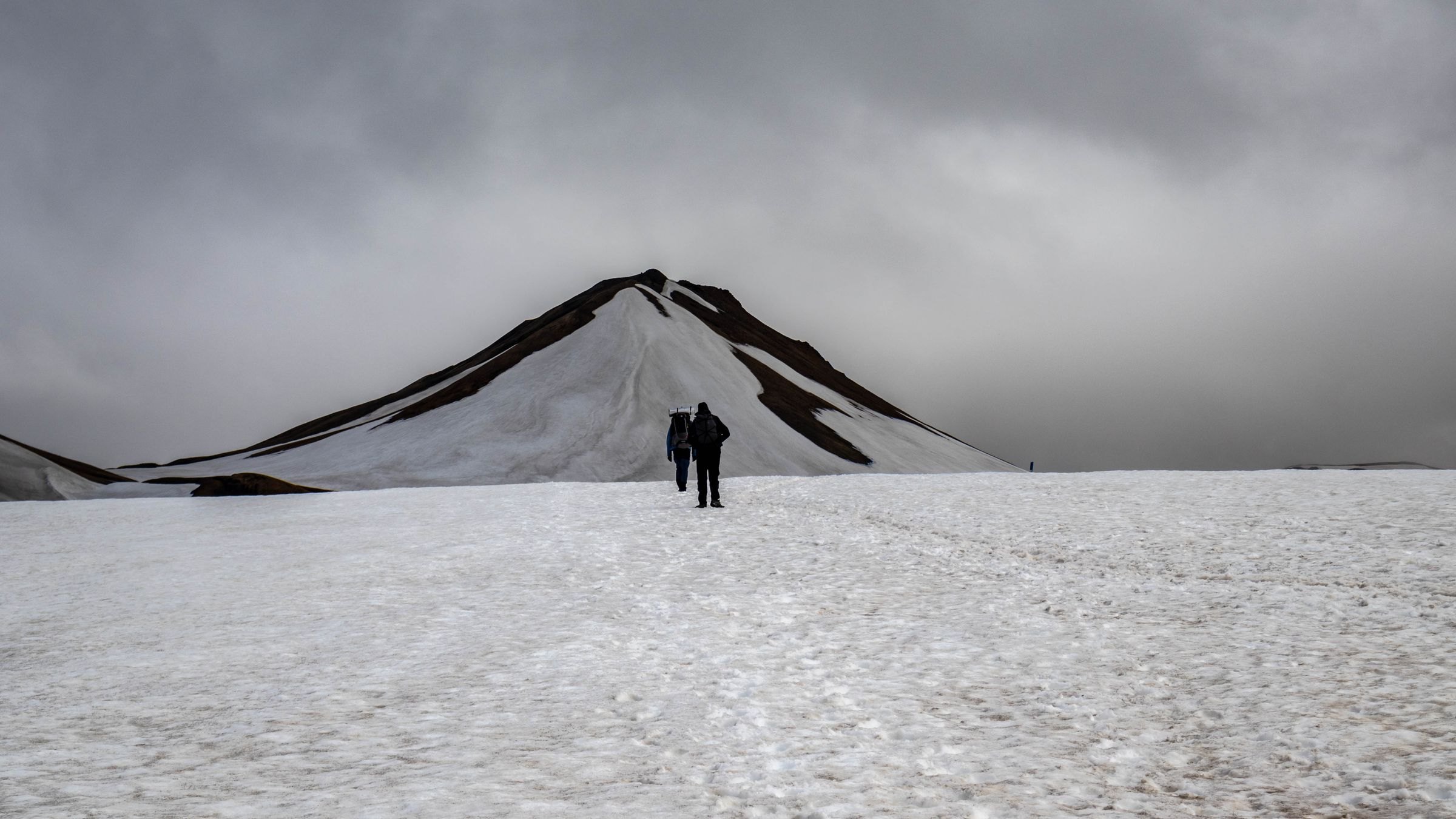 Hikers crossing snowfields on the Laugavegur Trail