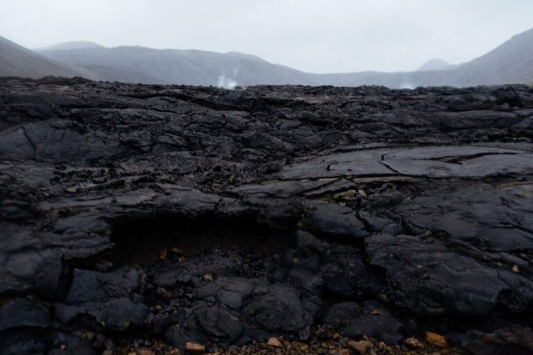 A lava field with steam rising