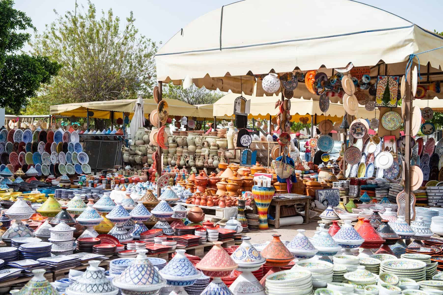 Colourful handmade ceramic dishes and plates on a local market stall