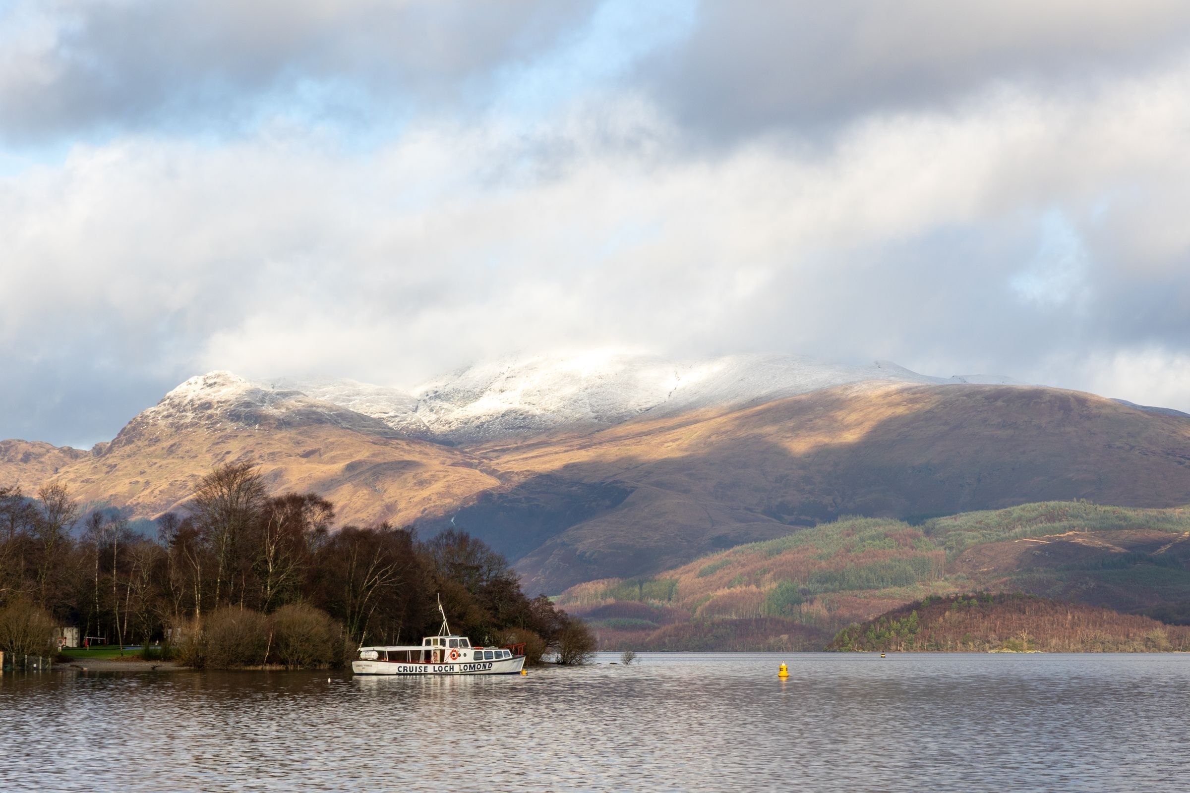 Loch Lomond below snow-capped mountains