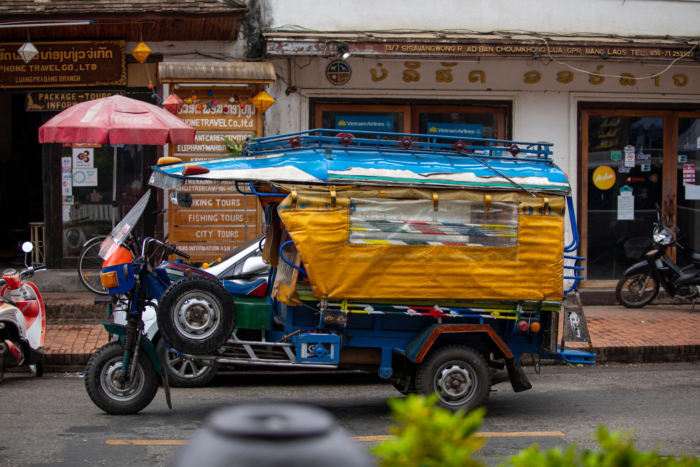 A tuk-tuk on a street in Luang Prabang
