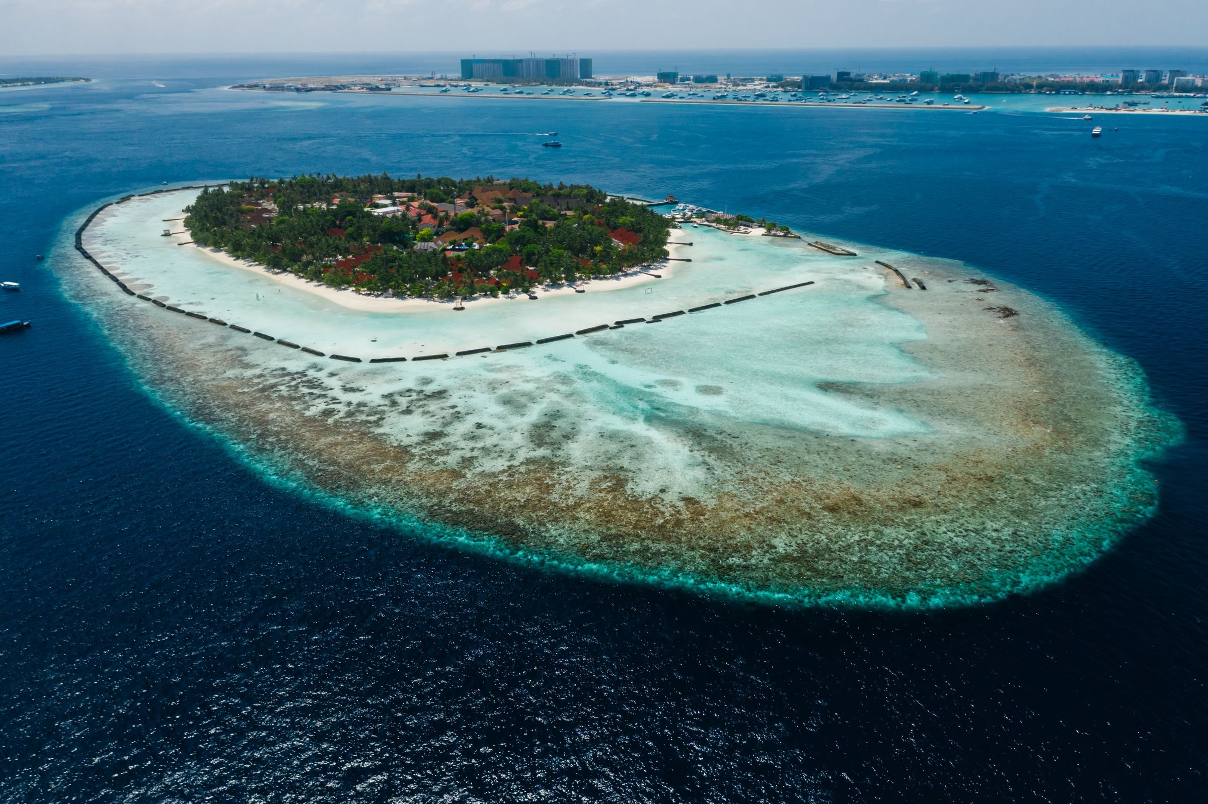 A tropical island ringed by reef in the Maldives