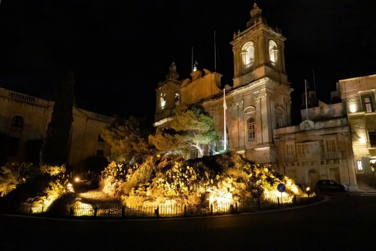 An illuminated nativity scene at night in Malta