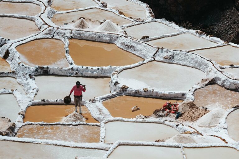 A woman working at the Maras salt pans