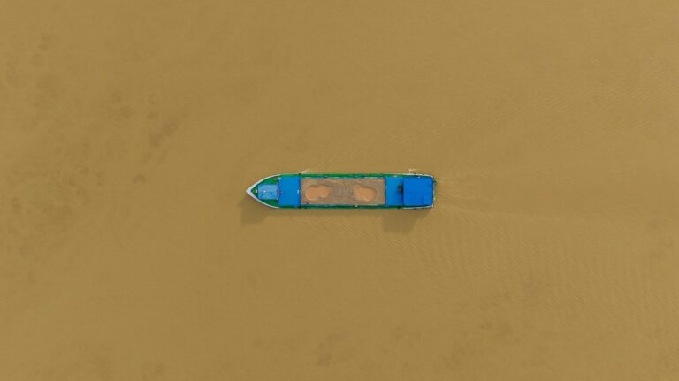 A boat on the brown waters of the Mekong