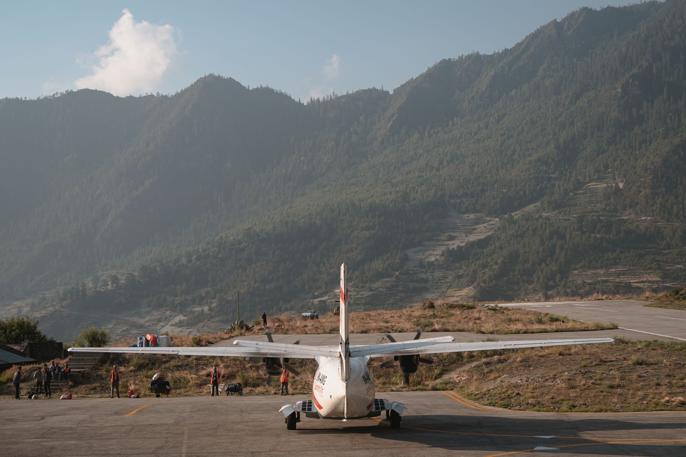 A small aircraft on a mountain airstrip in Nepal