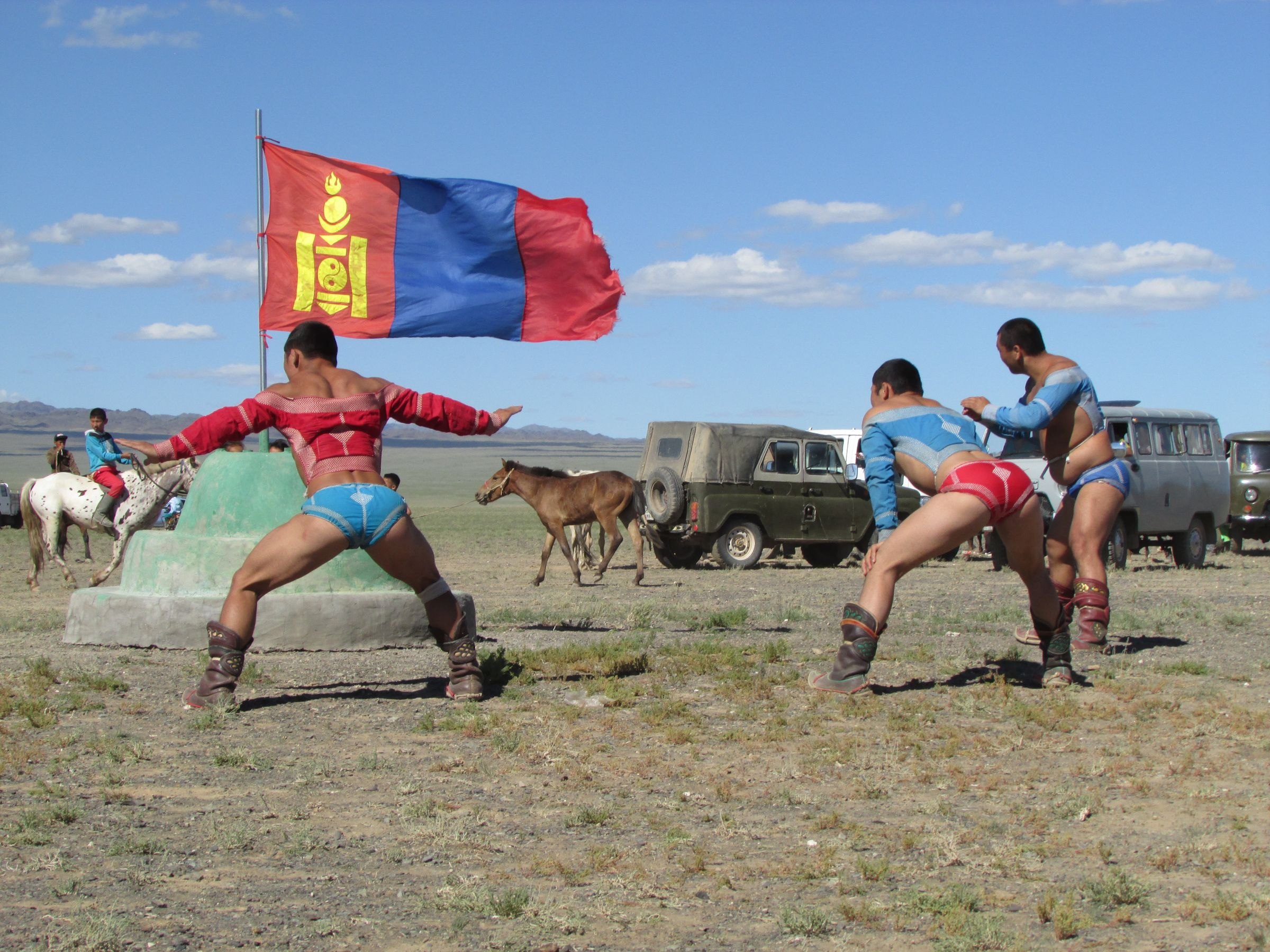 Wrestlers practising beneath the Mongolian flag
