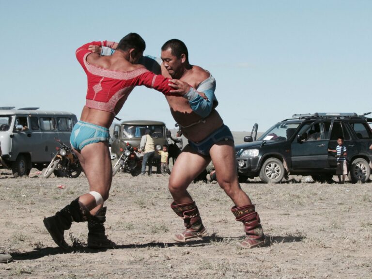 Two men wrestling at the Naadam festival