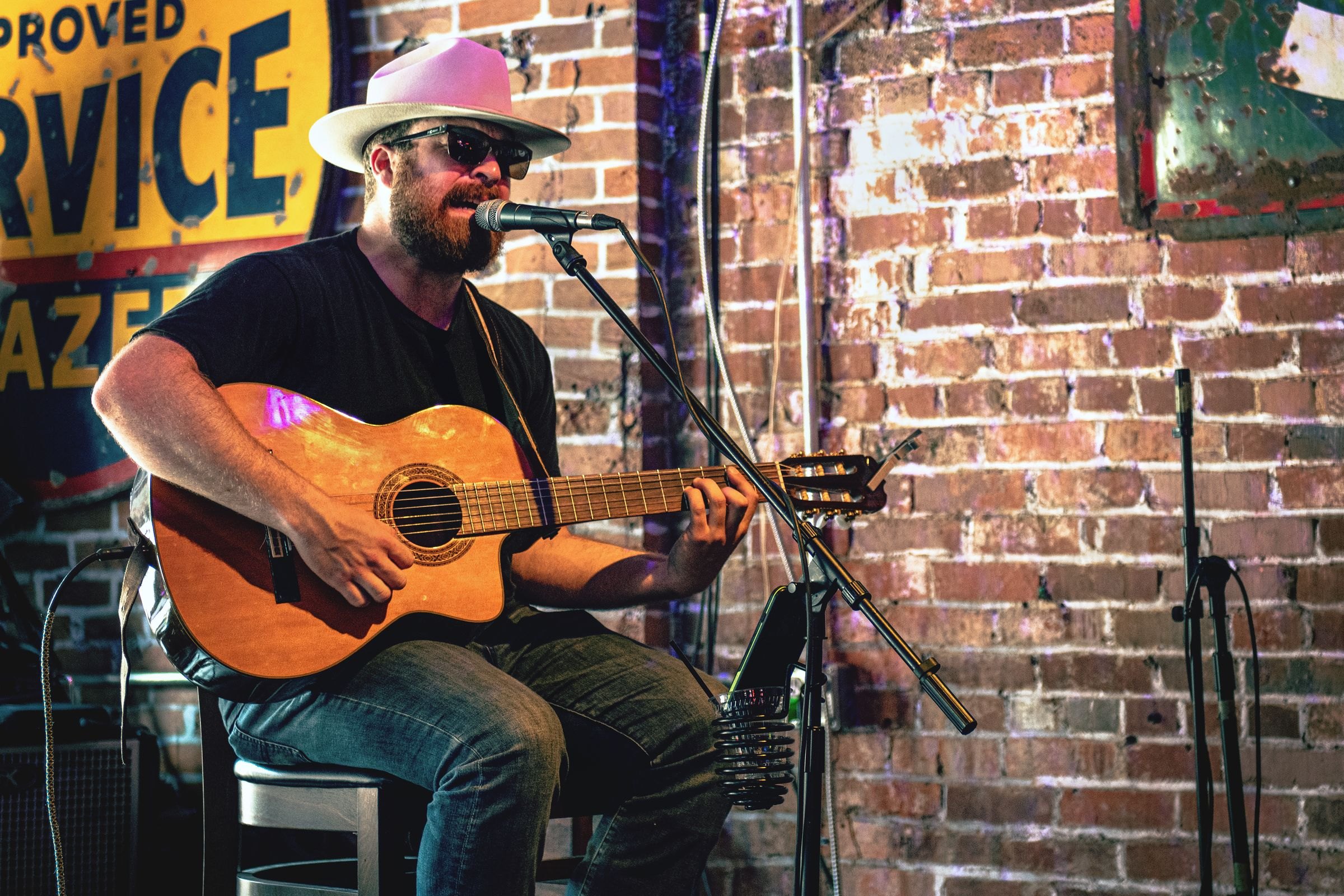 A musician playing guitar in a Nashville bar