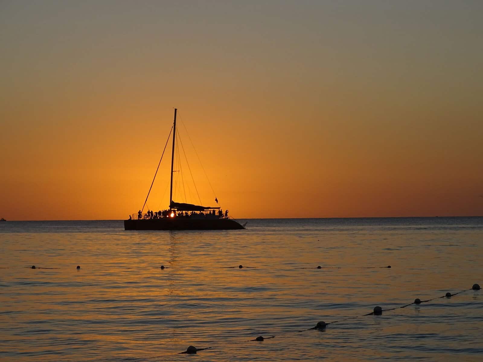 A sailing boat at sunset off Negril, Jamaica