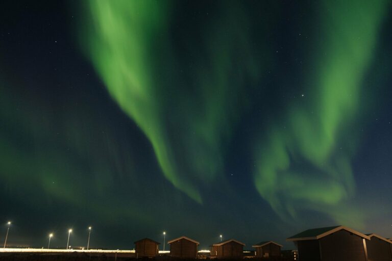 The Northern Lights over Icelandic cabins