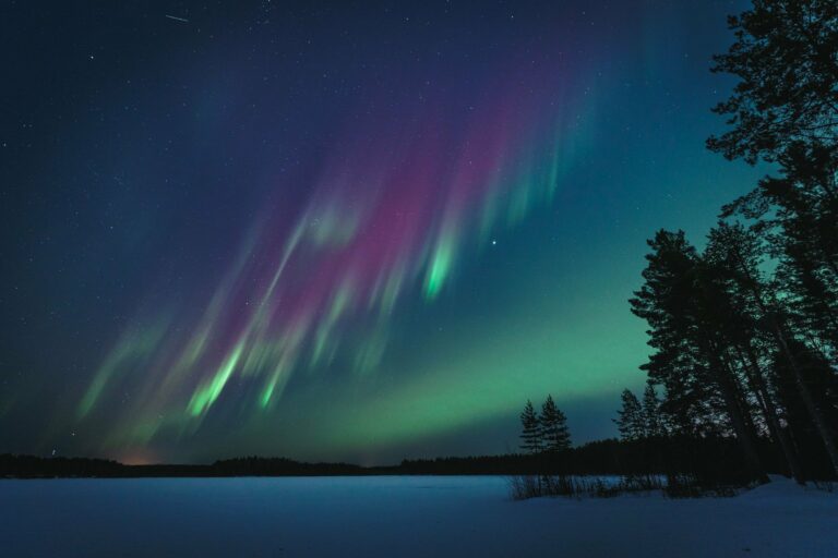 The Northern Lights over a lake in Finland