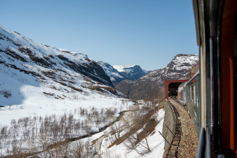 A train window view of Norway's snowy mountains
